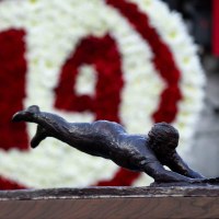 A miniture Pete Rose statue sits at a table George Foster at Great American Ball Park during the Cincinnati Red’s Pete Rose night at the ballpark on Wednesday, May 14, 2025 in Cincinnati.