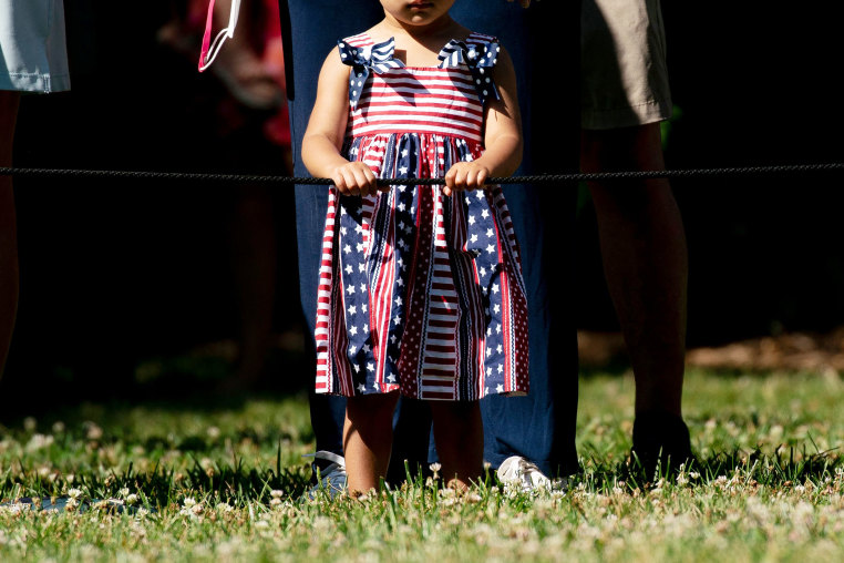 A child wears a U.S. flag dress during 